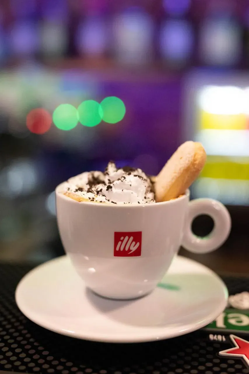 Cappuccino with a biscuit, on the bar