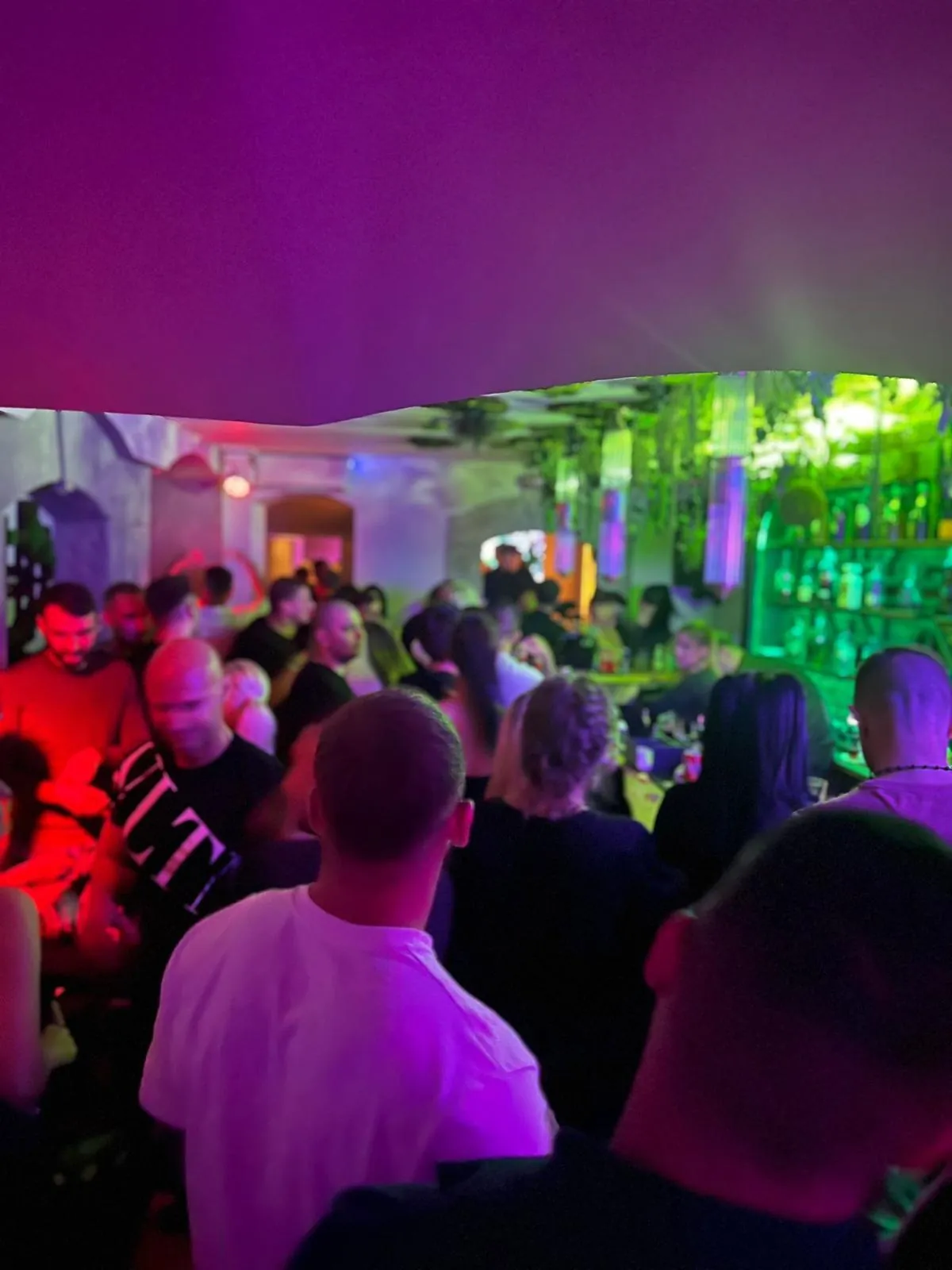 A full floor, the DJ in the archway