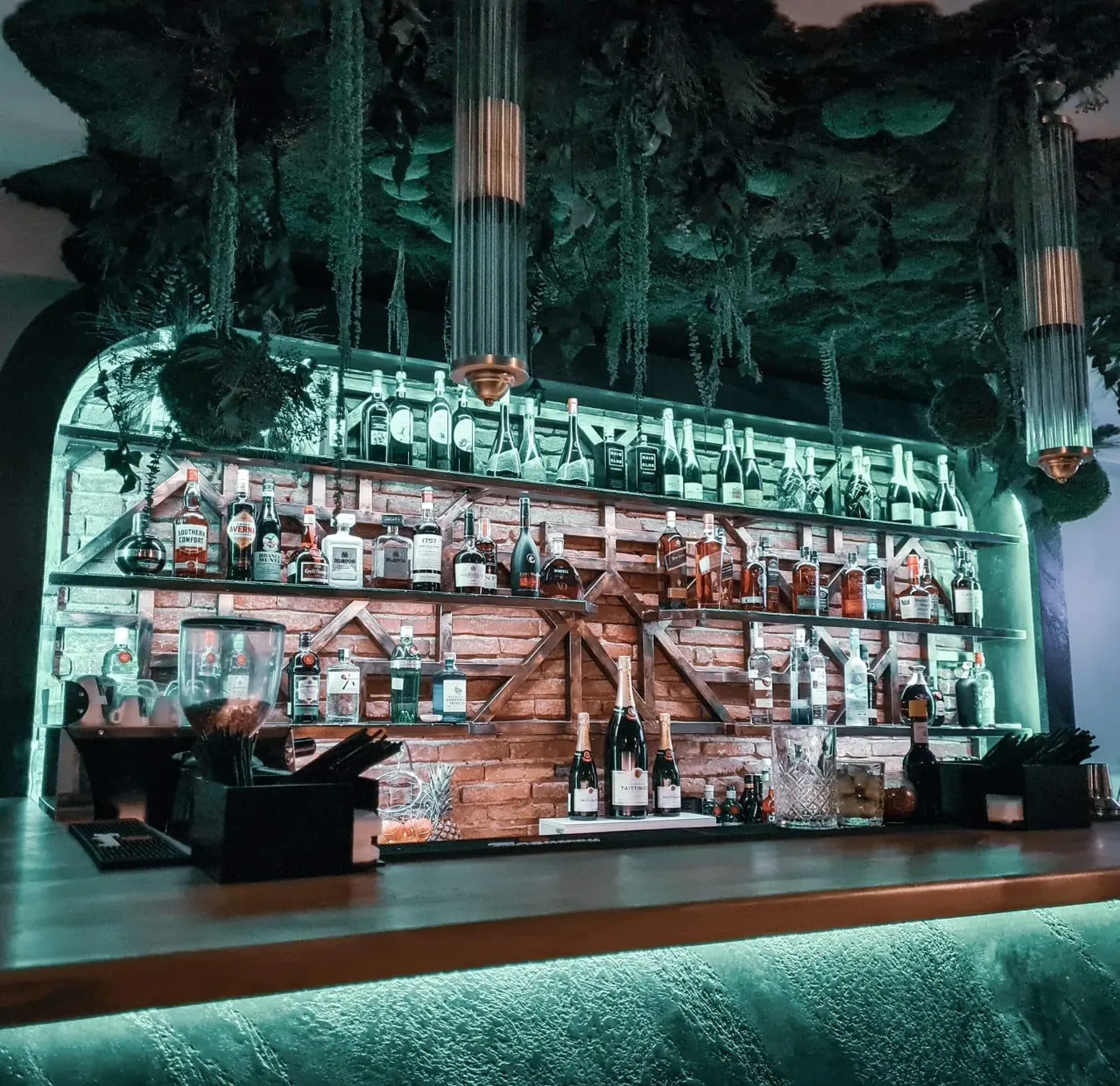 The back bar: three shelves of bottles on brick